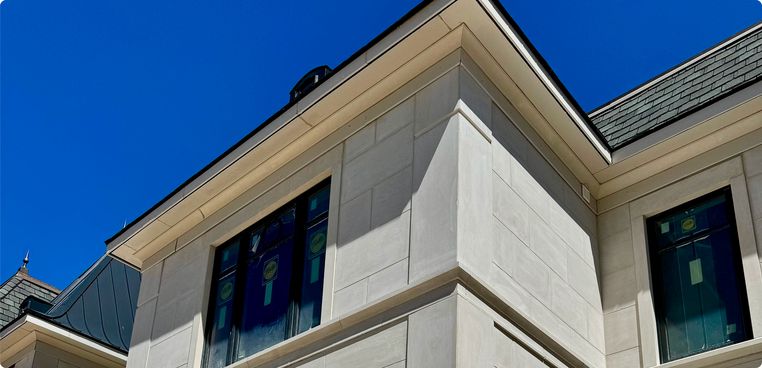 Corner of stone building with stained-glass windows